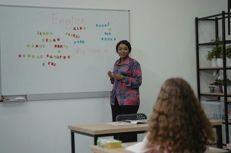 Teacher helping her students learn a new language